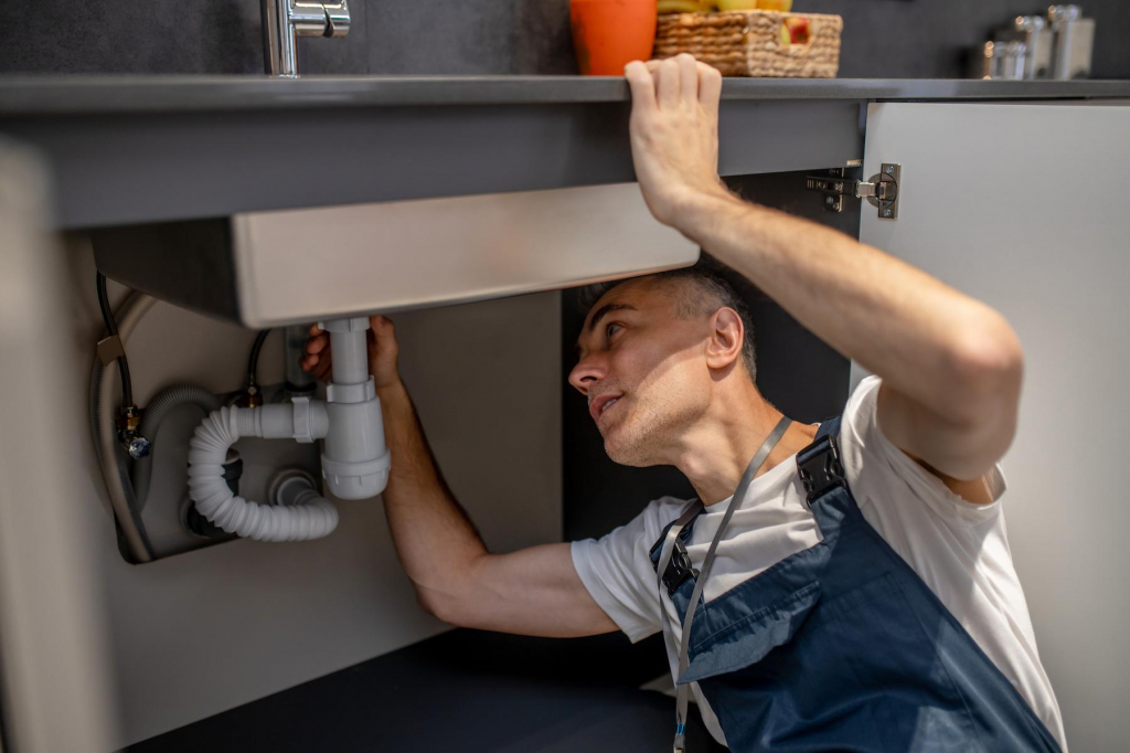 plumber-repair-experienced-attentive-middleaged-man-examining-bottom-kitchen-sink (1).jpg